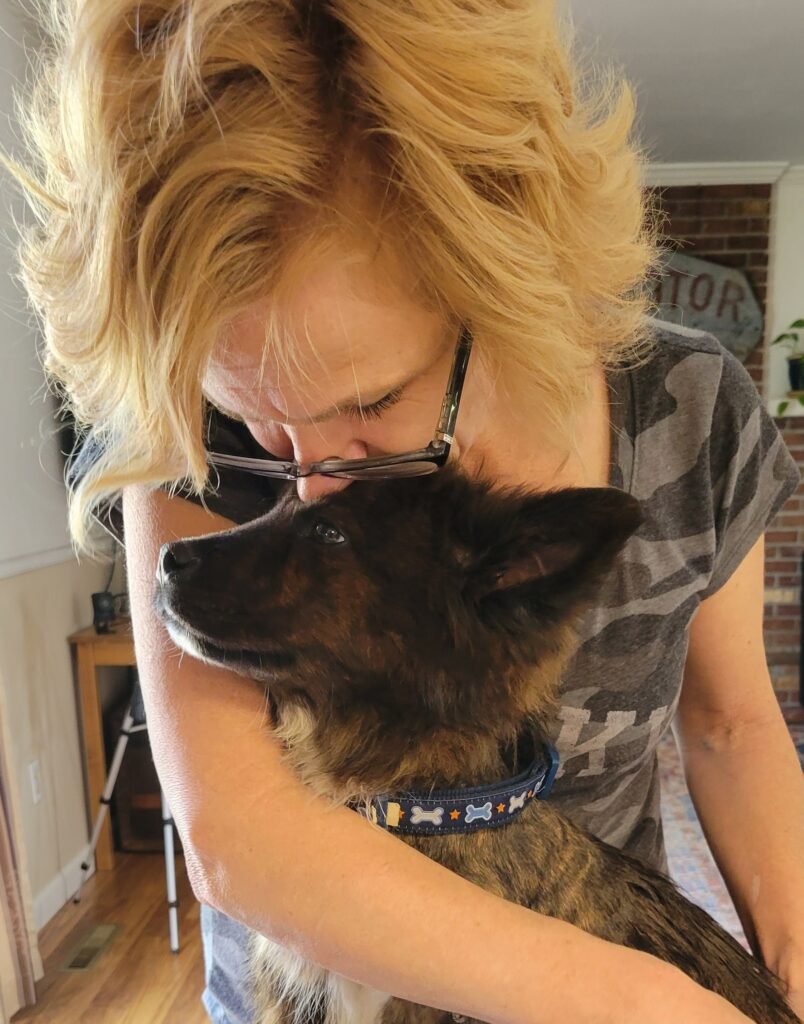 Virginia Power with brown rescued puppy Lt. Dan.