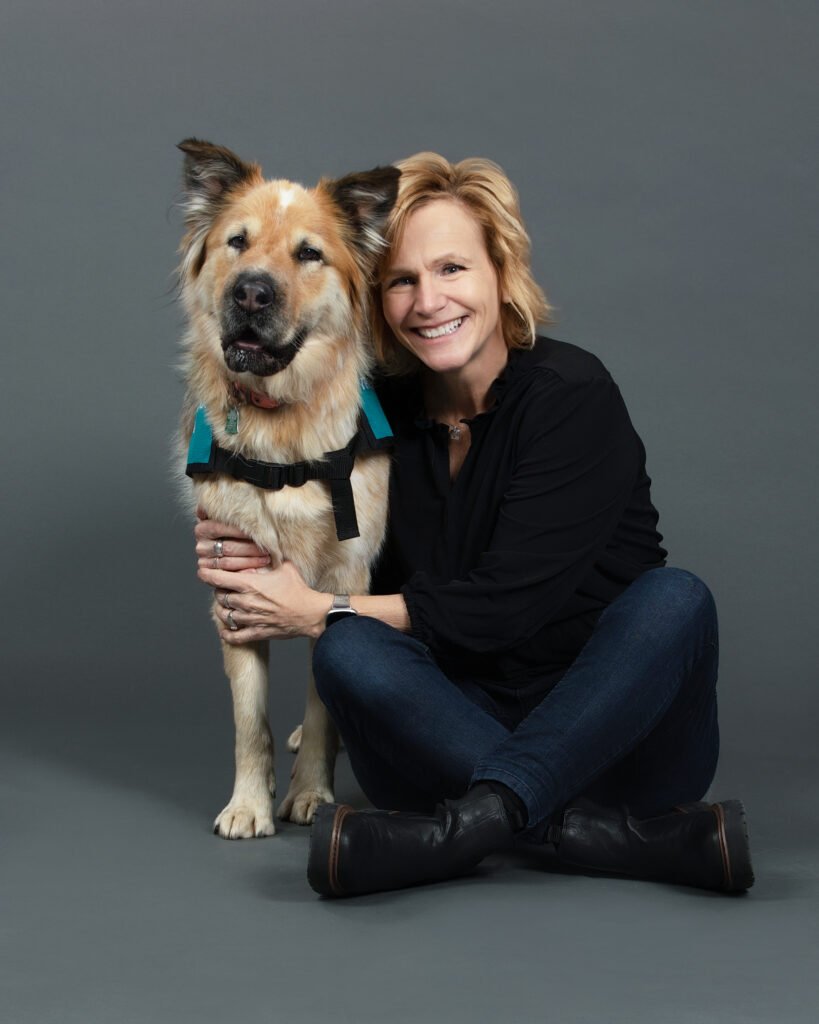 Virginia Power seated with therapy dog Poppy.